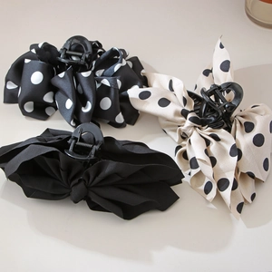 Three handmade French polka dot bow hair claws in black and beige minimalist styles