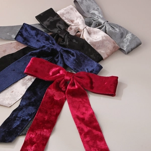 Close-up of premium velvet bow hair clips in various elegant colors with soft texture