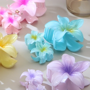 Set of colorful Plumeria flower hair claws in pink, blue and yellow gradient resin