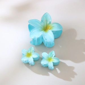 Set di tre mollette per capelli a forma di frangipani blu e giallo in varie dimensioni