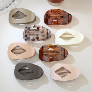 Flat oval hair claws in matte earth tones and tortoiseshell finish displayed in a set