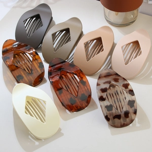 Detailed top view of diamond-shaped hair claws in various matte colors and leopard patterns