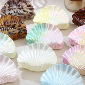Elegant scallop shell hair claw clips in various pearlescent and tortoiseshell colors