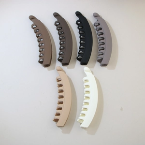 Detailed view of large matte banana hair clips in six assorted neutral colors