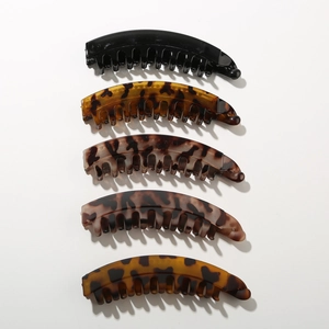 Vertical set of five assorted matte and tortoiseshell resin banana hair clips for ponytails