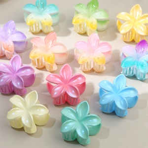 Colorful 4.5cm frangipani flower hair claws in multiple pastel gradient colors