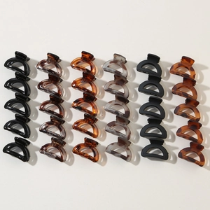 Detailed array of mini semi-circle hair claws in black, tortoise shell, and amber finishes