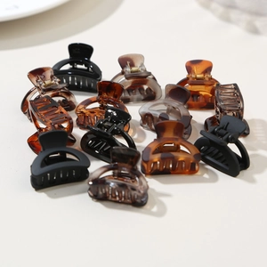 Macro detail of assorted mini claw clips set in tortoise shell and matte finishes