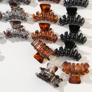 Set of 12 hair claw clips in black, amber, and grey with a durable metal spring