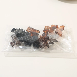 Detailed view of 12-piece mini hair claw set in milk coffee tones and classic colors