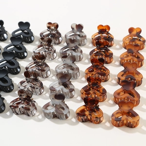 Set of 12 mini heart-shaped claw clips in multiple colors like marble and tortoiseshell