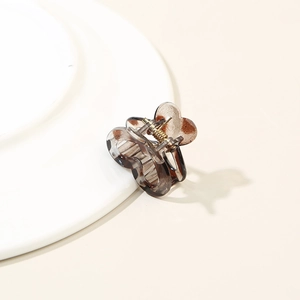 Close-up of heart-shaped mini hair claw clip with brown tortoiseshell pattern