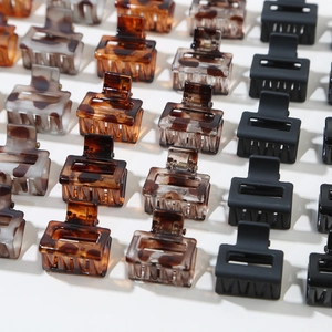 Close-up of mini rectangular hair claws in tortoiseshell and matte finishes