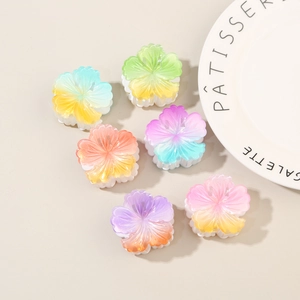 Detailed view of six resin flower hair claws in sweet pastel gradient colors