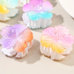 Gradient hibiscus flower hair claws in purple, pink and blue for summer beach styling