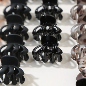 Detail of mini hair claws showing matte black, glossy black, and tortoiseshell finishes
