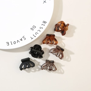 Detail view of octopus hair claw clips in tortoiseshell and matte finish textures