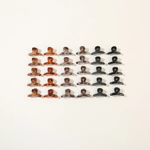 Detailed grid display of 30 mini resin hair claws in assorted matte and marble finishes