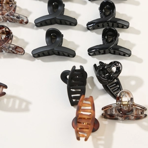 12-piece mini hair claw clips set in matte black, glossy black, and tortoise shell patterns