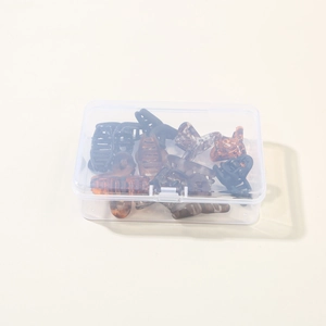 Detailed set of mini macaron hair claws in black and amber colors with a clear storage box