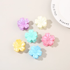 Detailed macro view of six colorful flower hair claws with pearlized satin finish