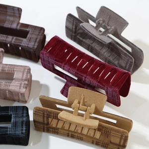 Elegant flocked plaid hair claw clips in autumn winter colors on a plain white background