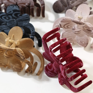 Elegant clover flower hair claws with velvet flocking and wood grain textures in various colors