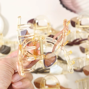 Detail of elegant resin hair claw clip showing amber texture and strong metal spring