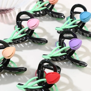 Detail view of colorful 3D tulip hair claws in pink, orange, blue, and purple set