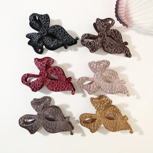 Flat lay of six flocked velvet bow hair claws in diverse retro colors with lace patterns