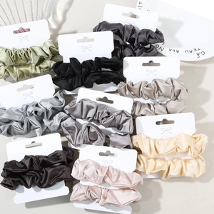 Detail shot of multi-color satin scrunchies sets displayed on white cards