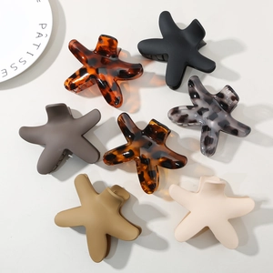 Detailed view of colorful starfish hair claws in tortoise shell and matte finishes