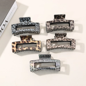 Flat lay of five large square leopard print hair claws in various stylish animal patterns