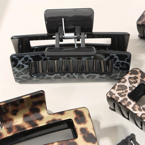 Elegant leopard print and black rectangular claw clips with hollow resin design