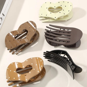 Lot de 5 barrettes cheveux cœurs et rayures tons chauds présentées sur un magazine de mode