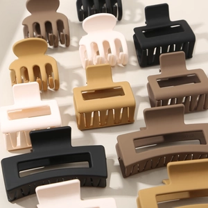Matte finish hair claws in neutral colors featuring rectangular and curved shark clips