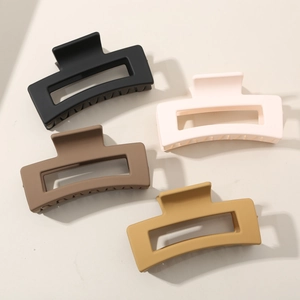 Detailed view of 4-pack matte large hair claws in black, beige, coffee, and yellow