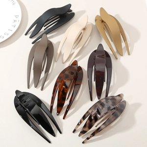 Flat lay of fishtail duckbill hair clips in various matte and tortoiseshell finishes