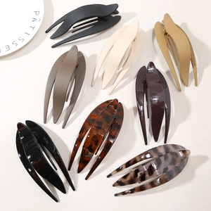 Close-up of matte and glossy fishtail hair claws in multiple earth tone colors