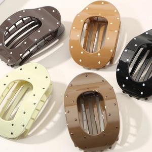 Five assorted polka dot oval hair claws in dark coffee, beige and black tones