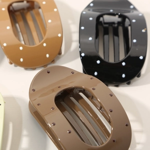 Chic oval polka dot hair claws in assorted earth tones for elegant hair styling