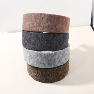Detail showing textures of four wide wool-like headbands in solid colors and leopard print