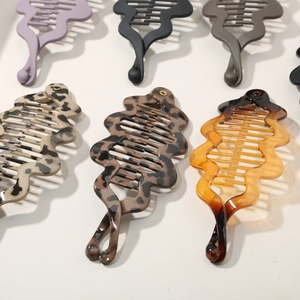 Various wavy banana clips for thick hair in leopard print, amber, and matte colors