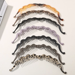 Vertical stack of assorted banana hair clips in tortoiseshell and solid colors for women