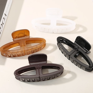 Elegant large oval hair claw clips in matte white, amber, black, and brown set