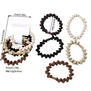 Detailed view of elastic hair ties in earth tones with brand card packaging and sizes