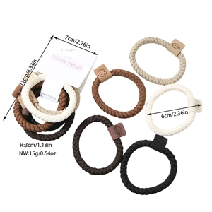 Detail of 5-piece thick woven hair ties in earth tones with handmade leather labels