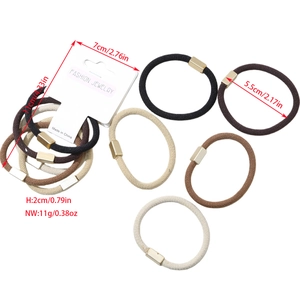 Close-up of high-elasticity hair ties with gold metal buckles on a display card