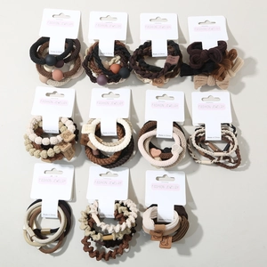 Detail view of multi-style earth-toned elastic hair ties with premium bead and bow accents