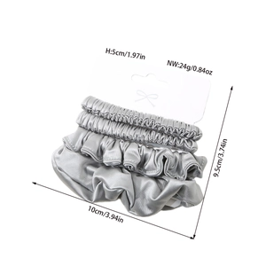 Three-piece set of silver-grey silk-like scrunchies with elastic bands and dimension tags